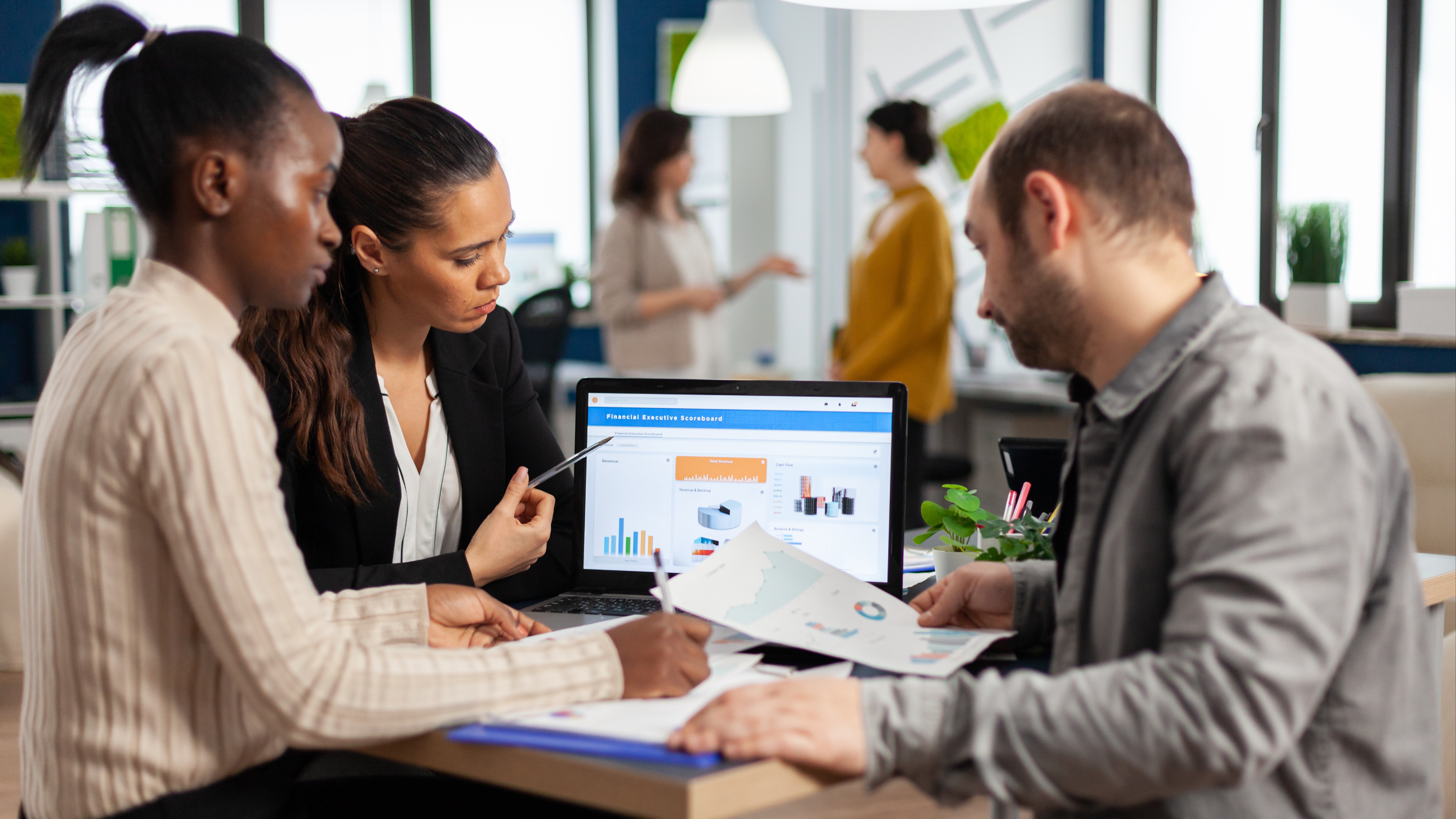 Founder reviewing business cashflow with digital advisor screen